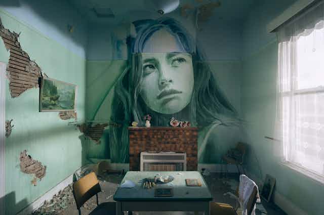 Painting of girl on wall of old room