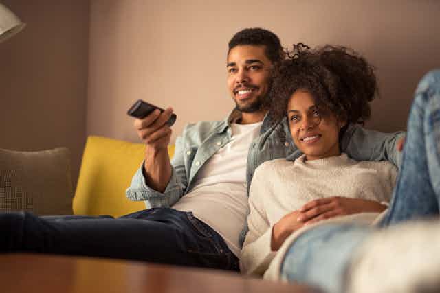 Image of a young couple watching TV.