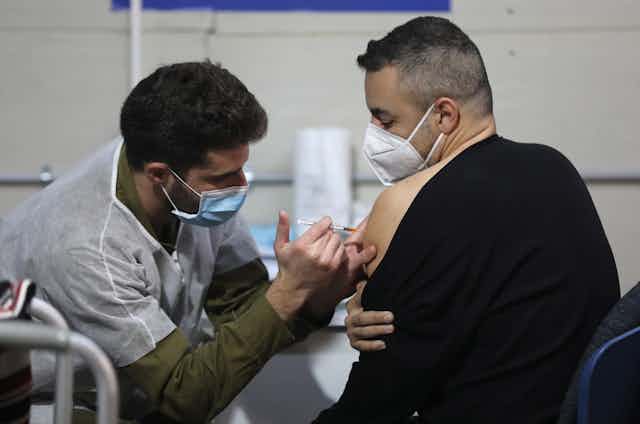 A man getting vaccinated for COVID-19 in Israel
