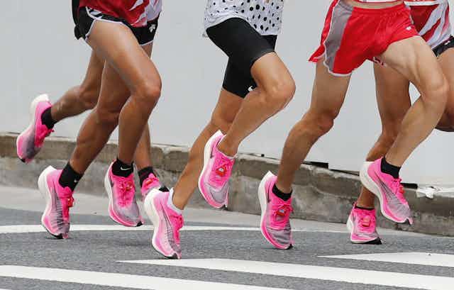 A shot of runners legs wearing the same pink running trainer