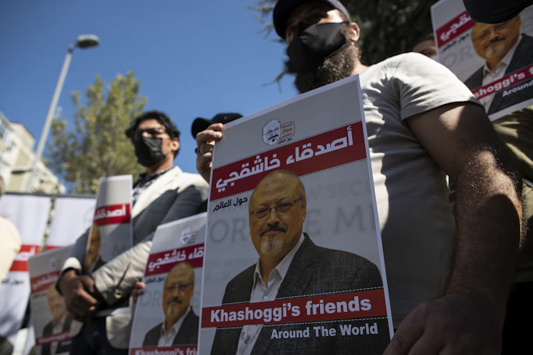 Protesters with a poster in Arabic and English about murdered dissident journalist Jamal Khashoggi.