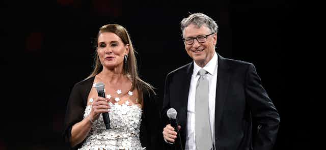 Melinda and Bill Gates, holding microphones