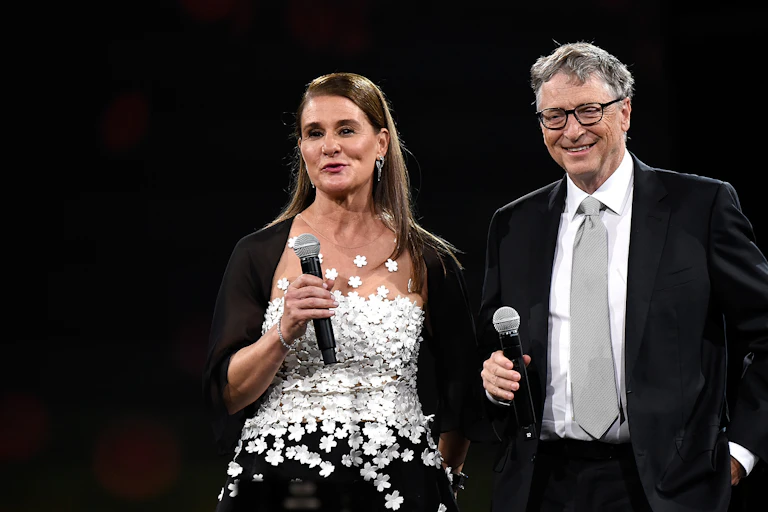 Melinda and Bill Gates, holding microphones