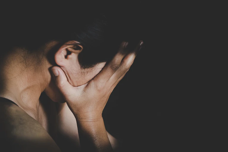 Woman with head in hands