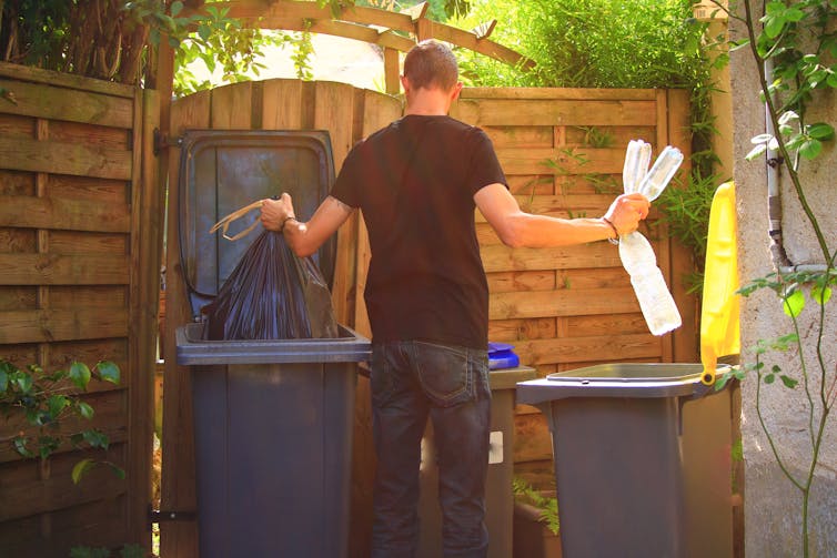 Man puts items in bins