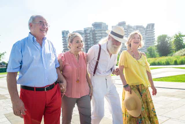 Two older couples enjoying a walk in the city