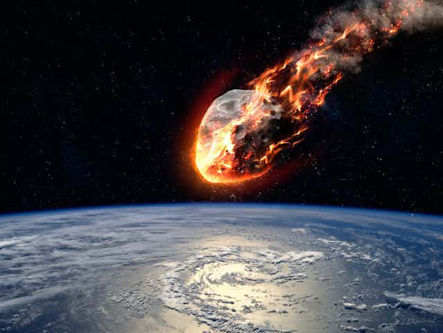 Drawing of an asteroid burning up as it approaches Earth, seen below.