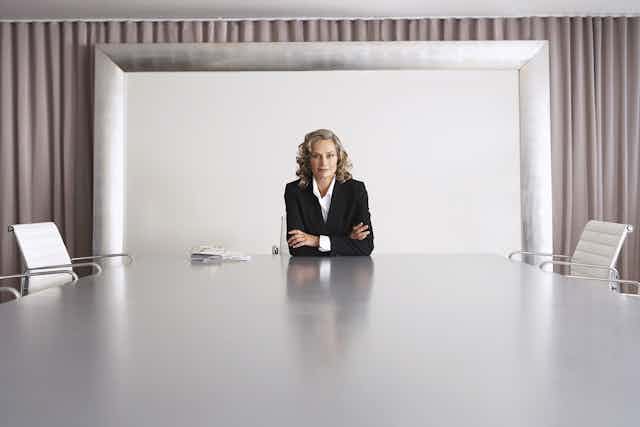 Woman at head of boardroom table