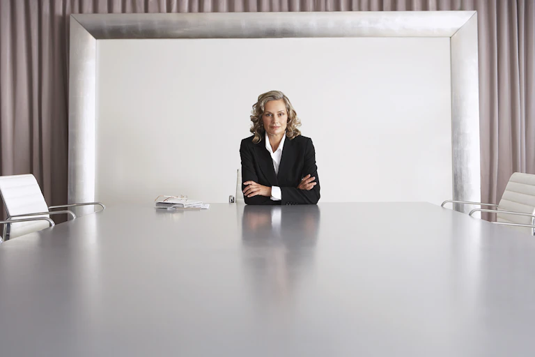 Woman at head of boardroom table