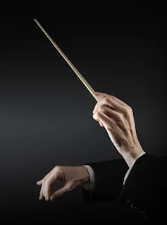 Female conductor waves wand