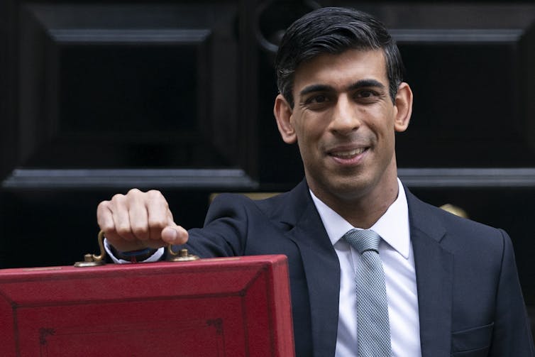 Rishi Sunak carrying large red briefcase outside Downing Street