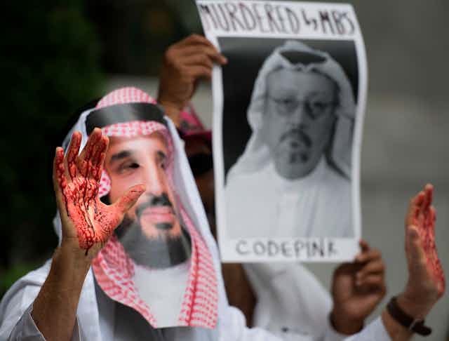 A demonstrator dressed as Saudi Arabian Crown Prince Mohammed bin Salman with blood on his hands protests outside the Saudi Embassy in Washington, DC, Oct.  8, 2018.