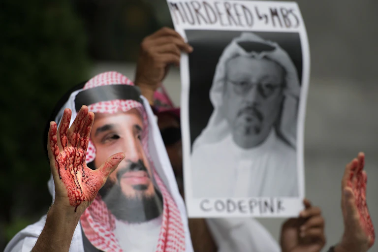 A demonstrator dressed as Saudi Arabian Crown Prince Mohammed bin Salman with blood on his hands protests outside the Saudi Embassy in Washington, DC, Oct. 8, 2018.