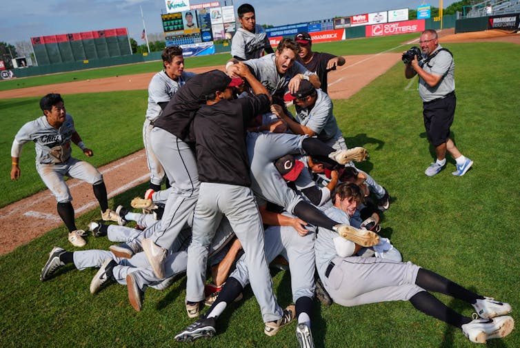 Baseball players celebrate on the field