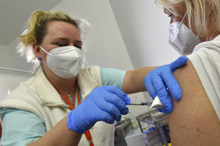 Health-care worker giving someone a COVID vaccine
