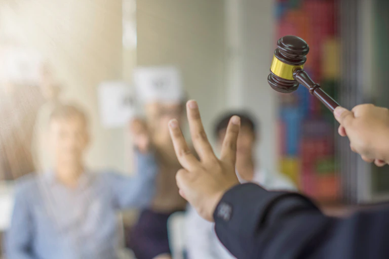 An auctioneer holds a hammer in an auction.