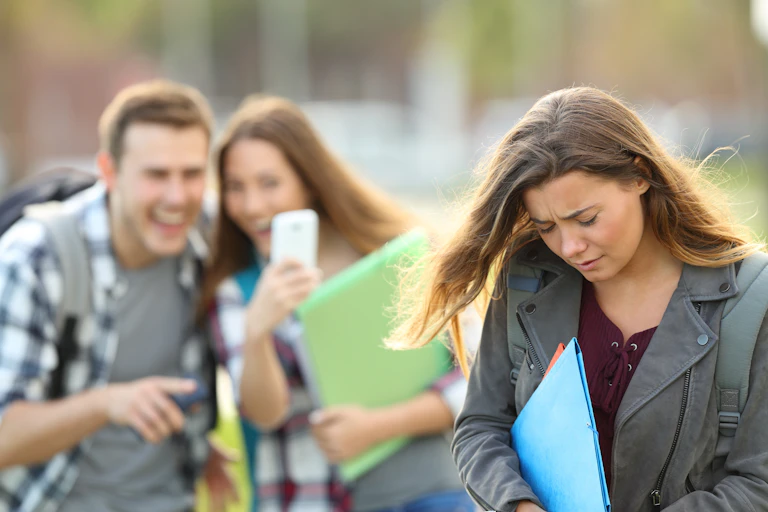Two students bullying a third student