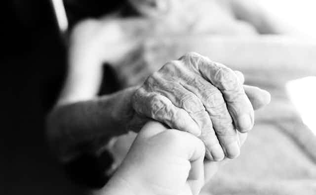 Close up of elderly woman's hand in black and white