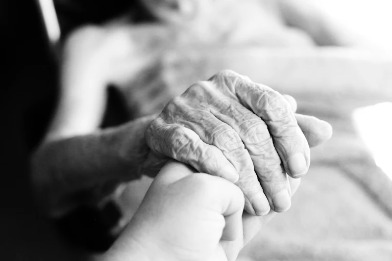 Close up of elderly woman's hand in black and white