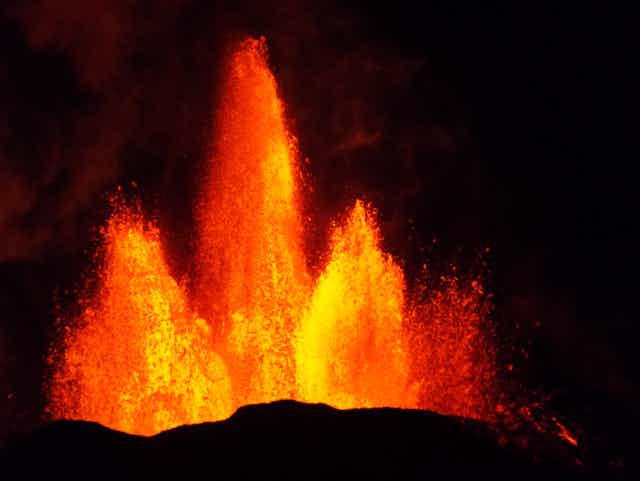 Iceland's Holurhraun volcano erupting with three large columns of lava.