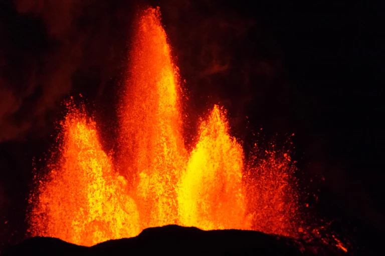 Iceland's Holurhraun volcano erupting with three large columns of lava.