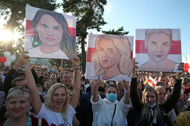 Supporters hold up posters of Belarus opposition figures Svetlana Tikhanovsksaya, Veronika Tsepkalo and Maria Kolesnikova during an election rally in July 2020. 