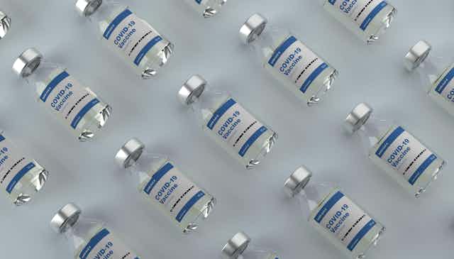 Vials of COVID vaccines laid out symmetrically