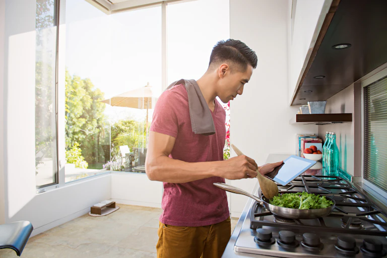 A man cooking green veg