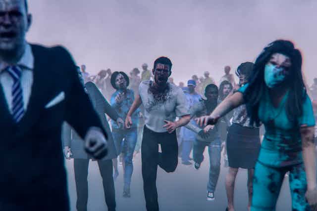 A horde of zombies running down the street.