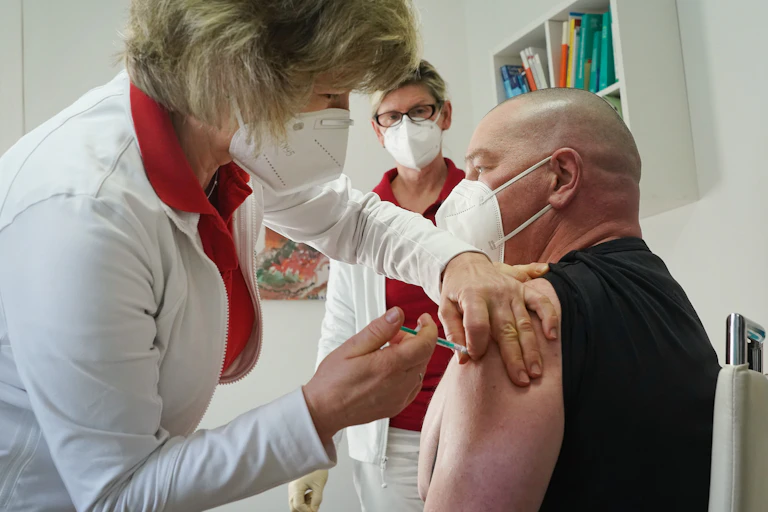 A health worker in Germany being vaccinated with the Oxford/AstraZeneca vaccine