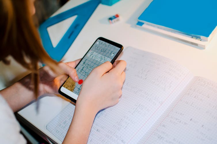 Child Learning over mobile phone using internet connection and smart application during self isolation at home.