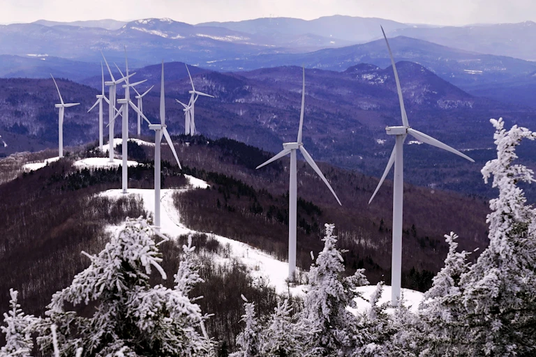 Wind turbines on a snowy ridge in Maine, February 2021