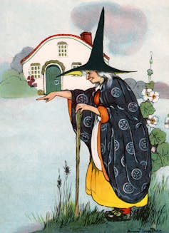 A witch, hunched over and wearing a tall, pointy hat, casts a spell.
