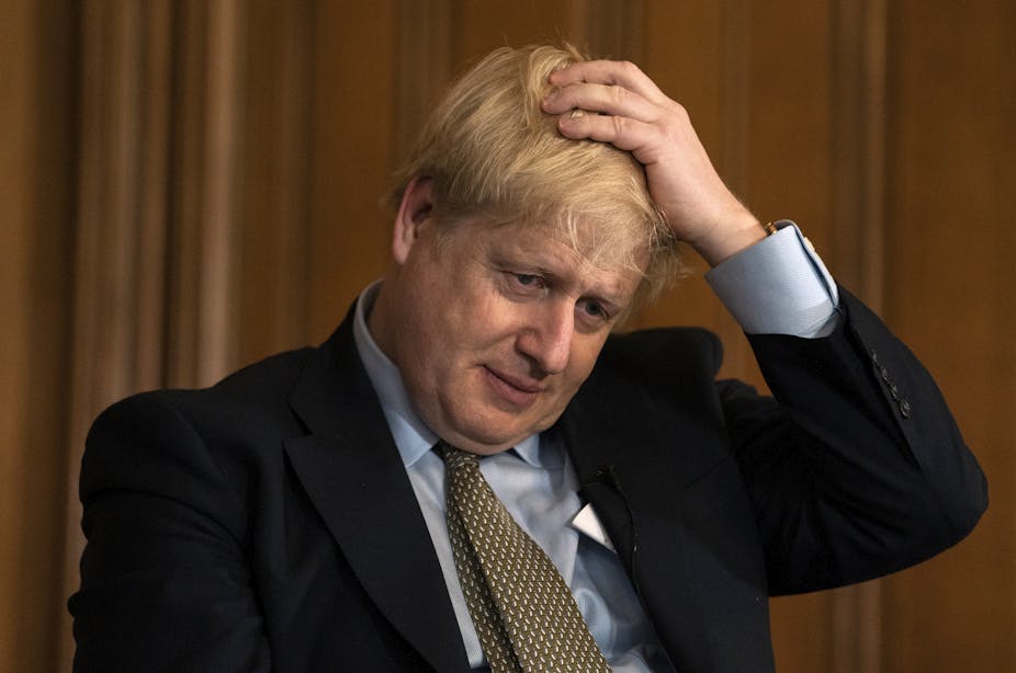 UK prime minister Boris Johnson with his hand on his head