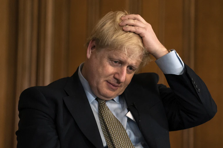 UK prime minister Boris Johnson with his hand on his head