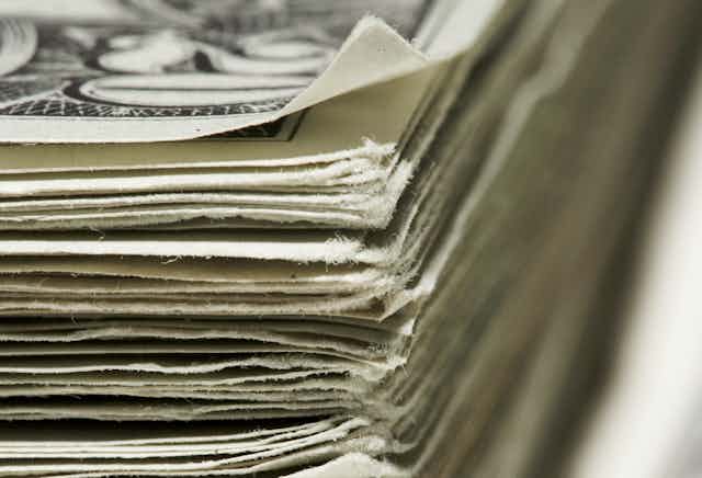 A closeup of stack of 20 dollar bills.