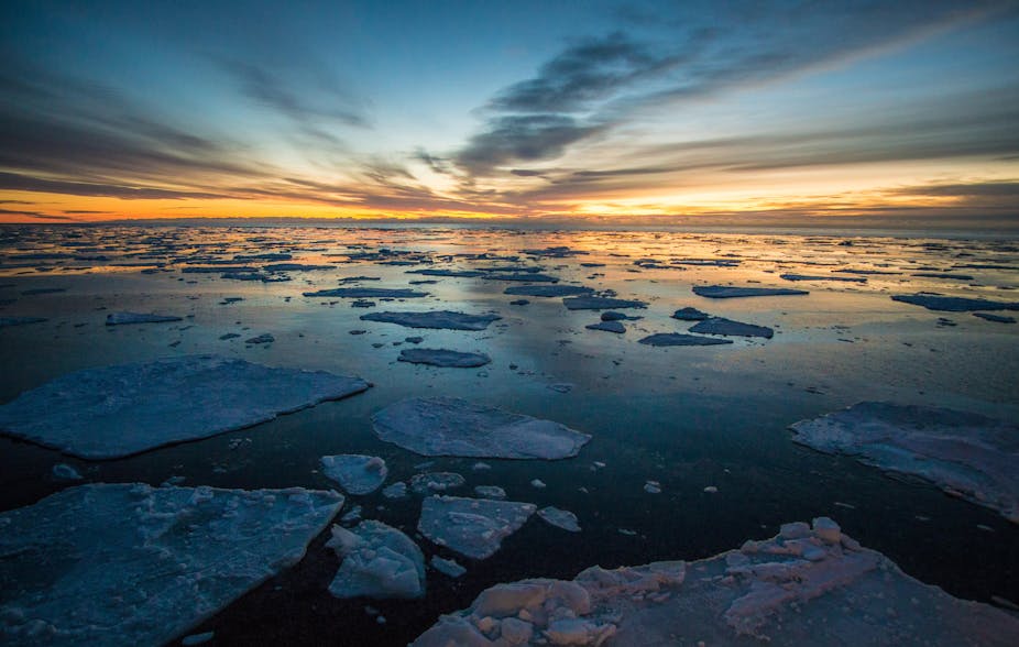 Sea ice with sun on horizon.