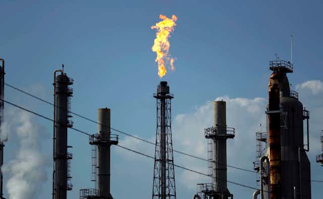 A flame burns at the Shell Deer Park oil refinery in Texas.