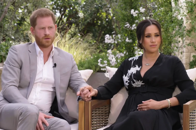 Prince Harry and Meghan Markle holding hands during interview
