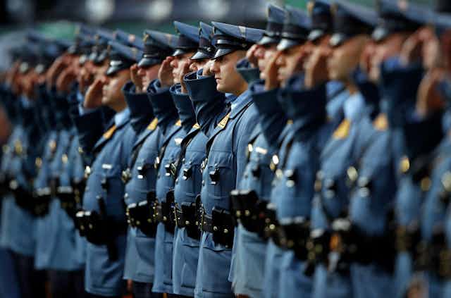 New Jersey state troopers in a line saluting