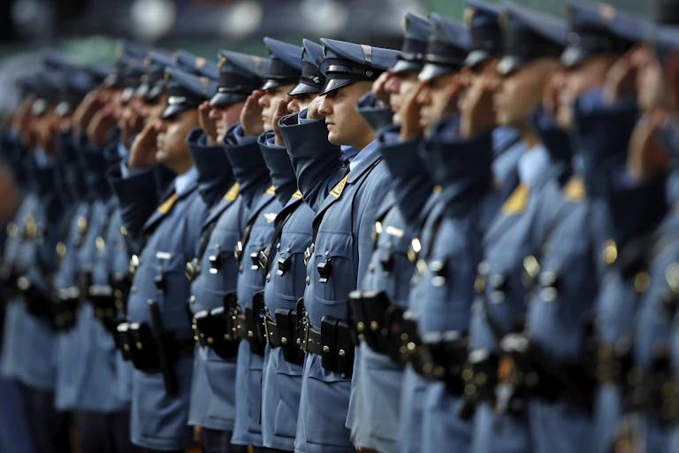 New Jersey state troopers in a line saluting