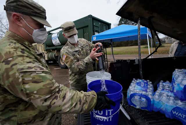 National Guard members supplying water during a disaster