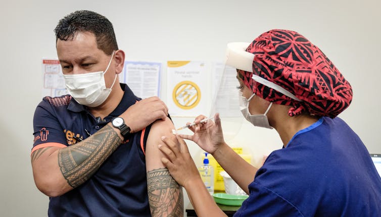 A nurse administering a COVID-19 vaccination