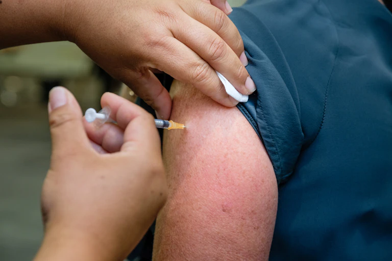 A nurse administering a COVID-19 vaccination