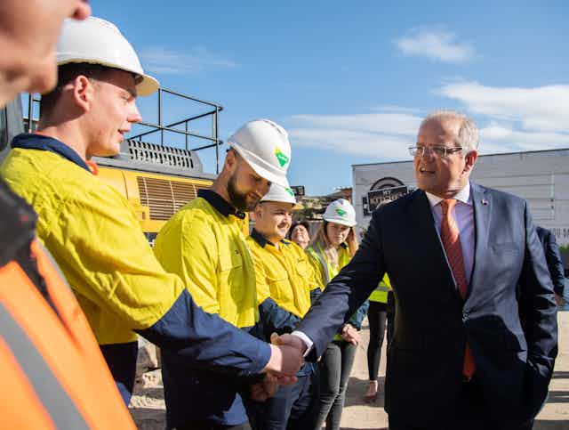 Scott Morrison shaking the hand of a construction worker