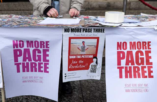 Posters and a petition at a stall for the 'No More Page Three' campaign.