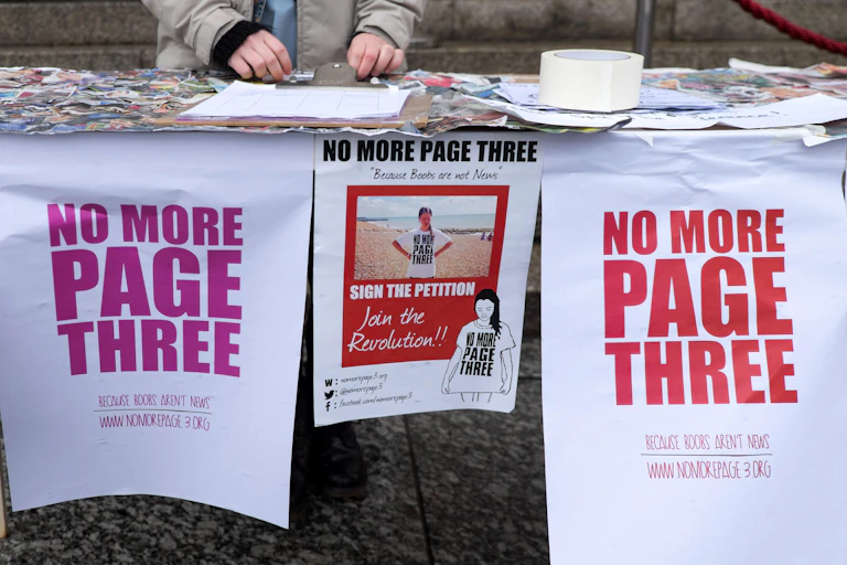 Posters and a petition at a stall for the 'No More Page Three' campaign.