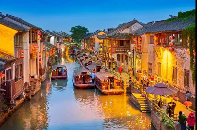 Shantang canal in Suzhou, eastern China, showing shops and boats plying their trade.ver in the city centre.