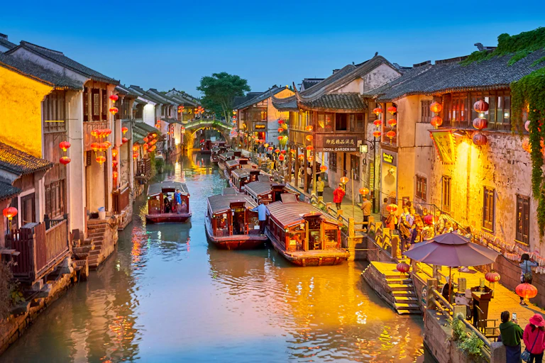 Shantang canal in Suzhou, eastern China, showing shops and boats plying their trade.ver in the city centre.