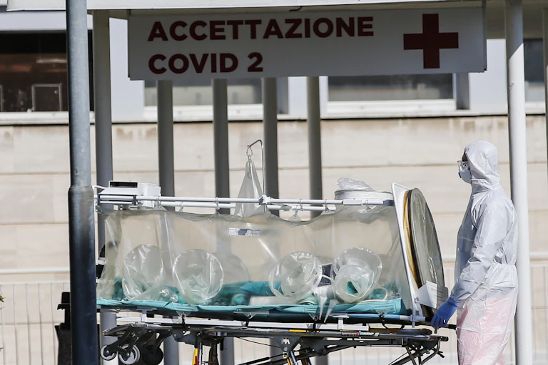 A hospital worker carries equipment in the early days of the pandemic.